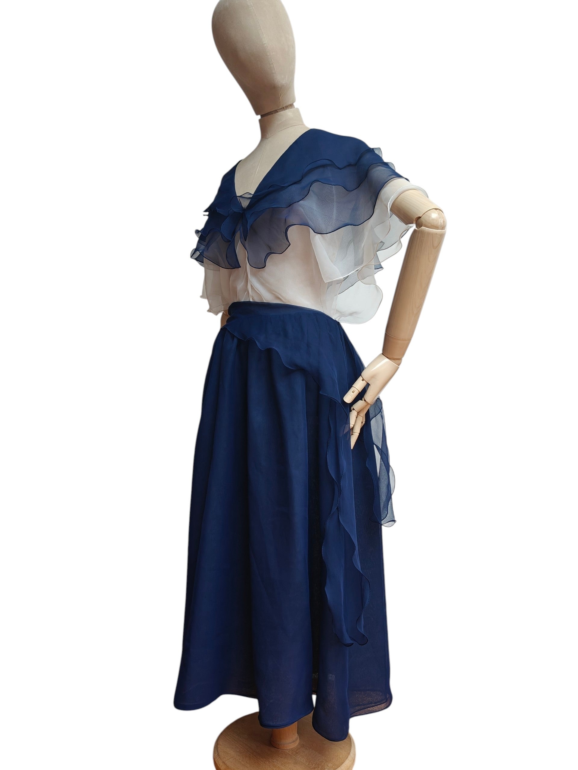 Mannequin wearing a blue and white dress on a white background