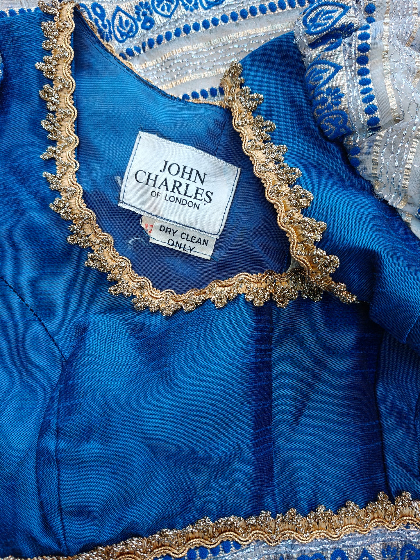 Blue fabric with gold embroidery and a John Charles label