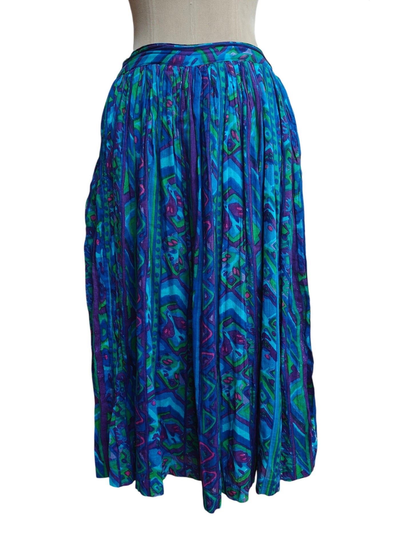 Blue patterned skirt on a mannequin against a white background