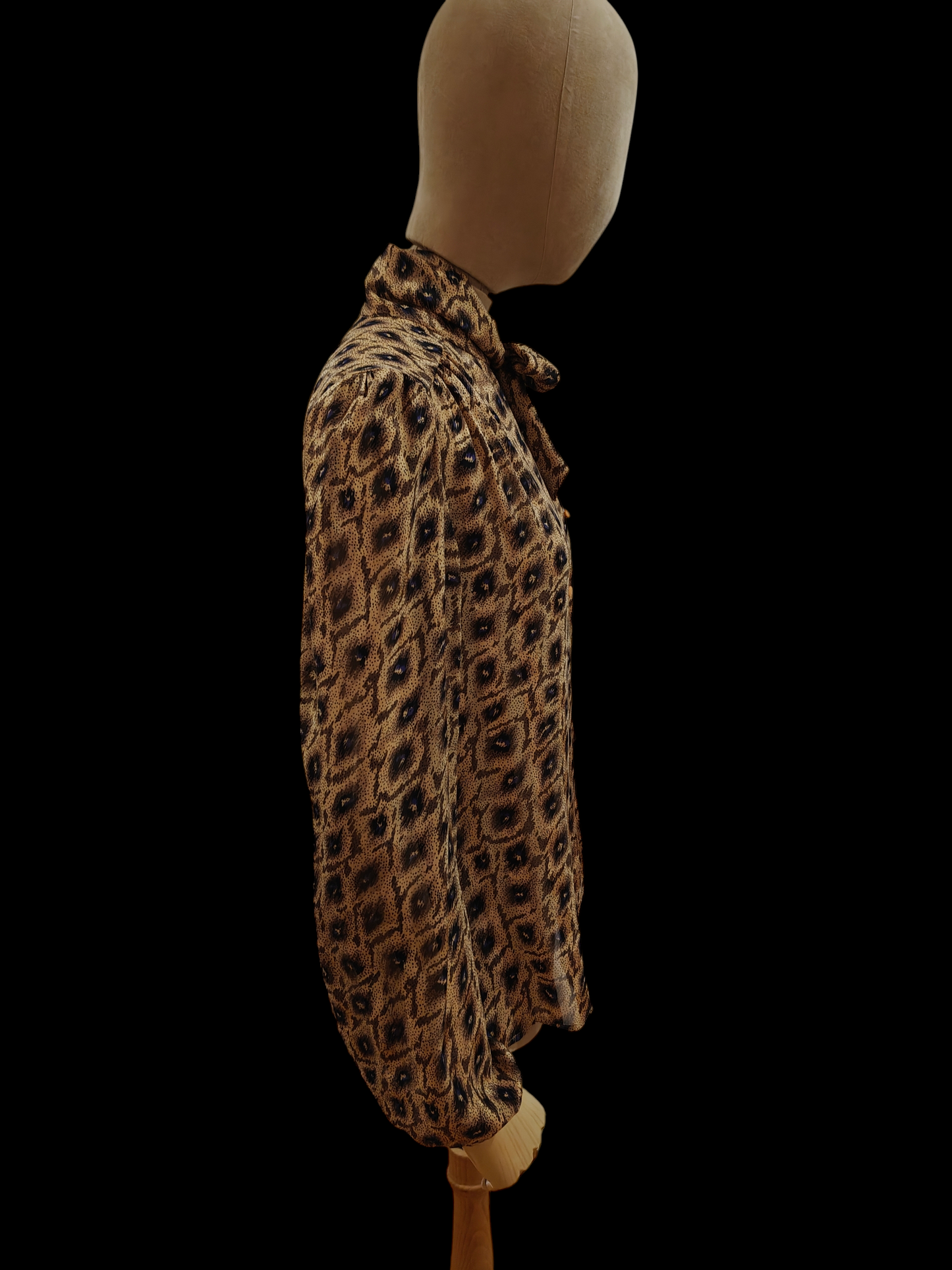 Mannequin wearing a leopard print outfit on a black background