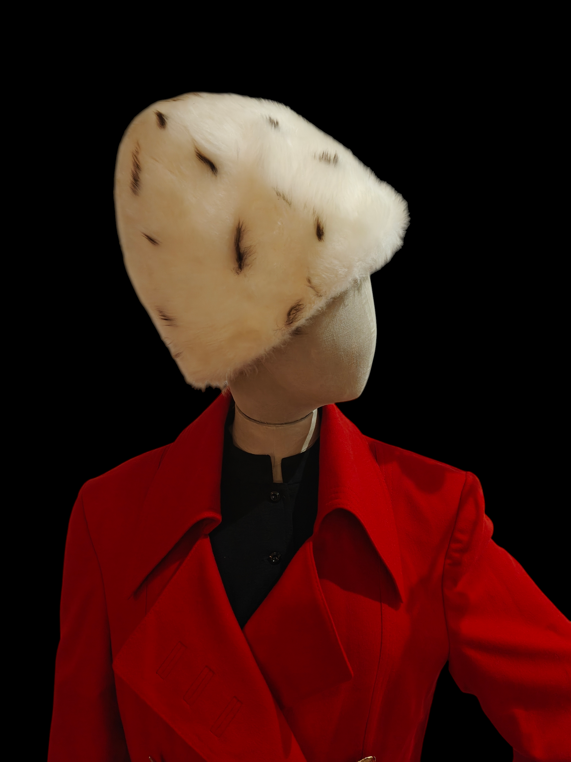 Mannequin wearing a red coat and white fur hat on a black background