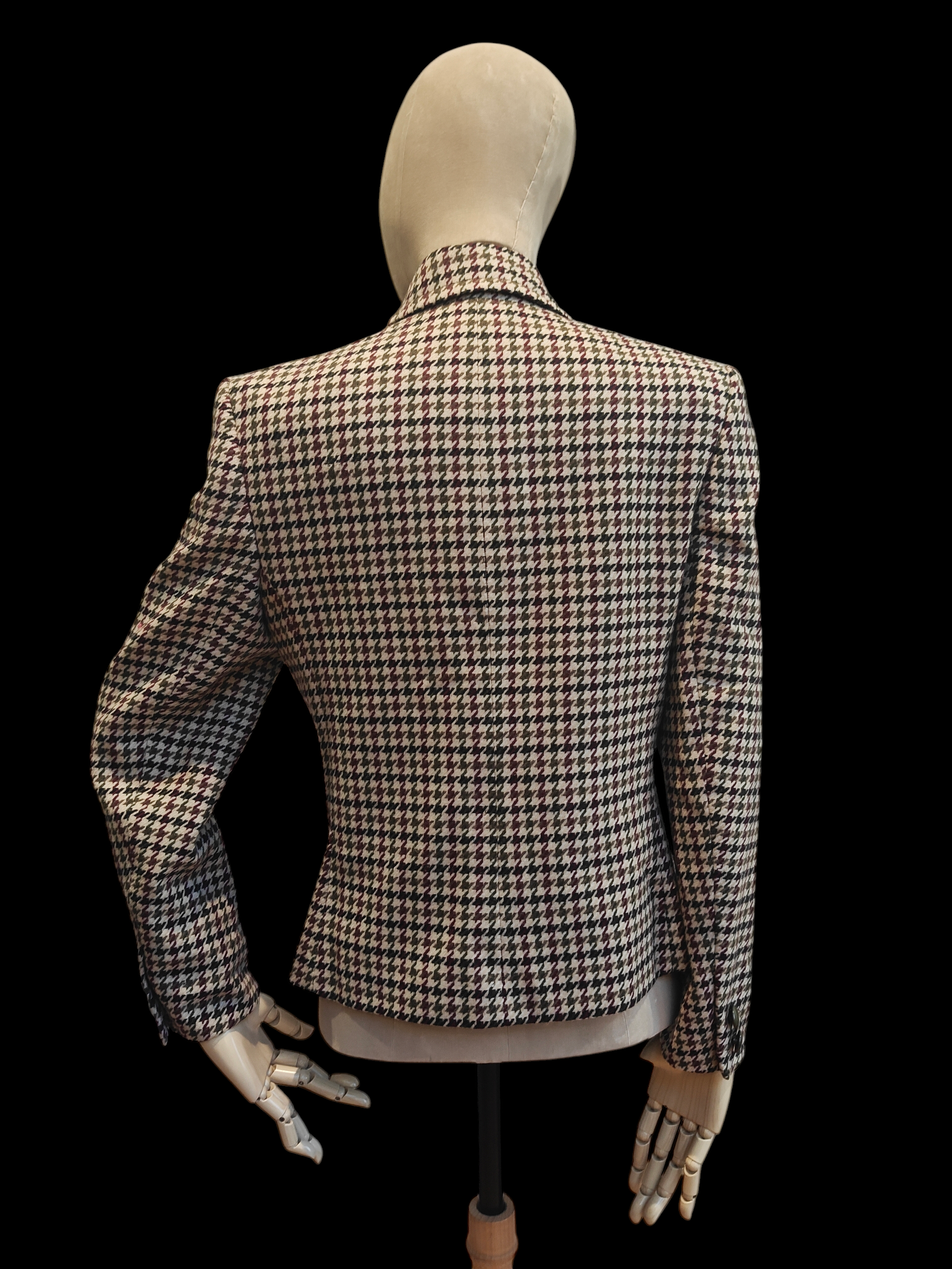 Houndstooth patterned blazer on a mannequin against a black background