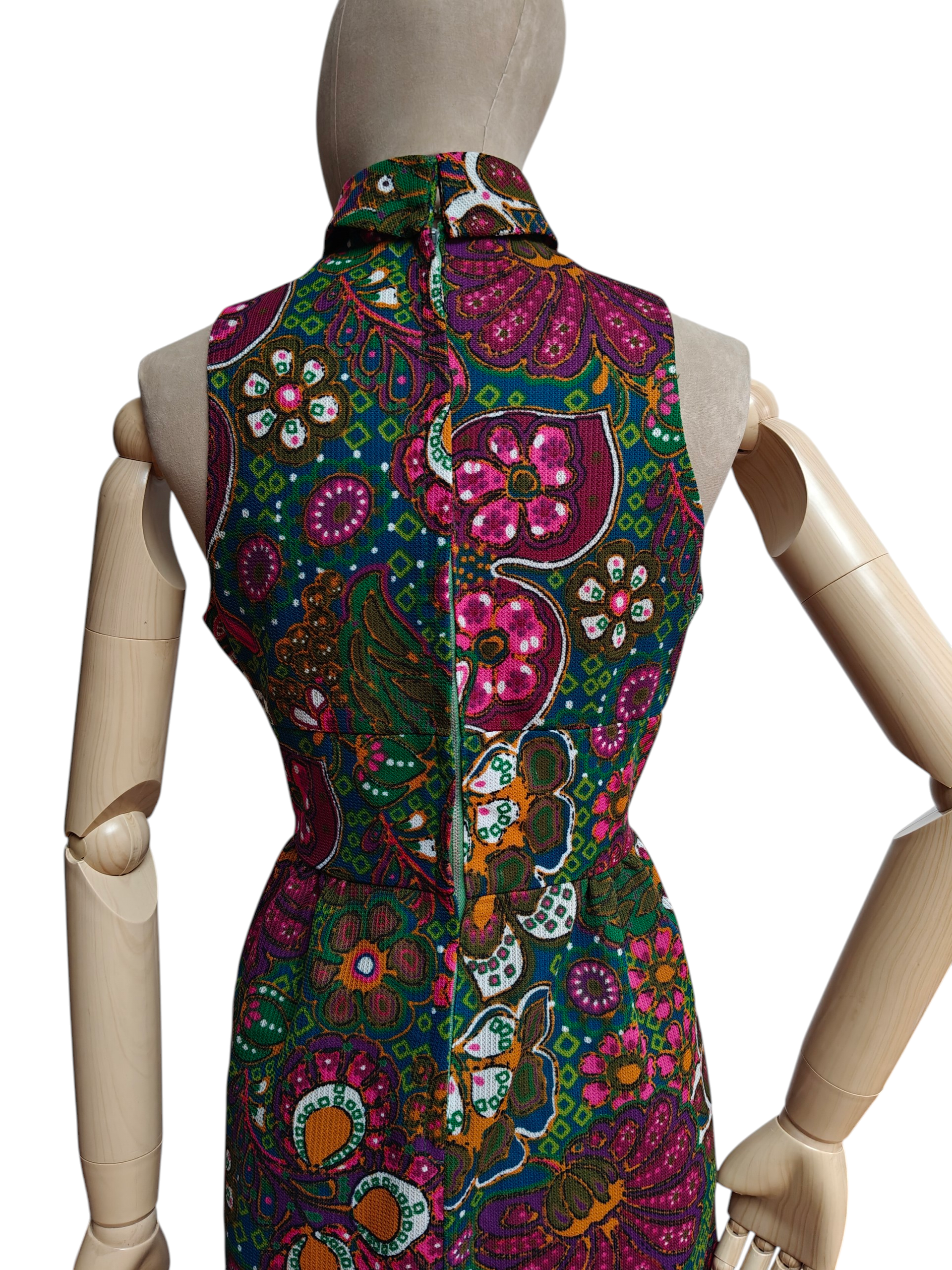 Colorful patterned dress on a mannequin against a white background