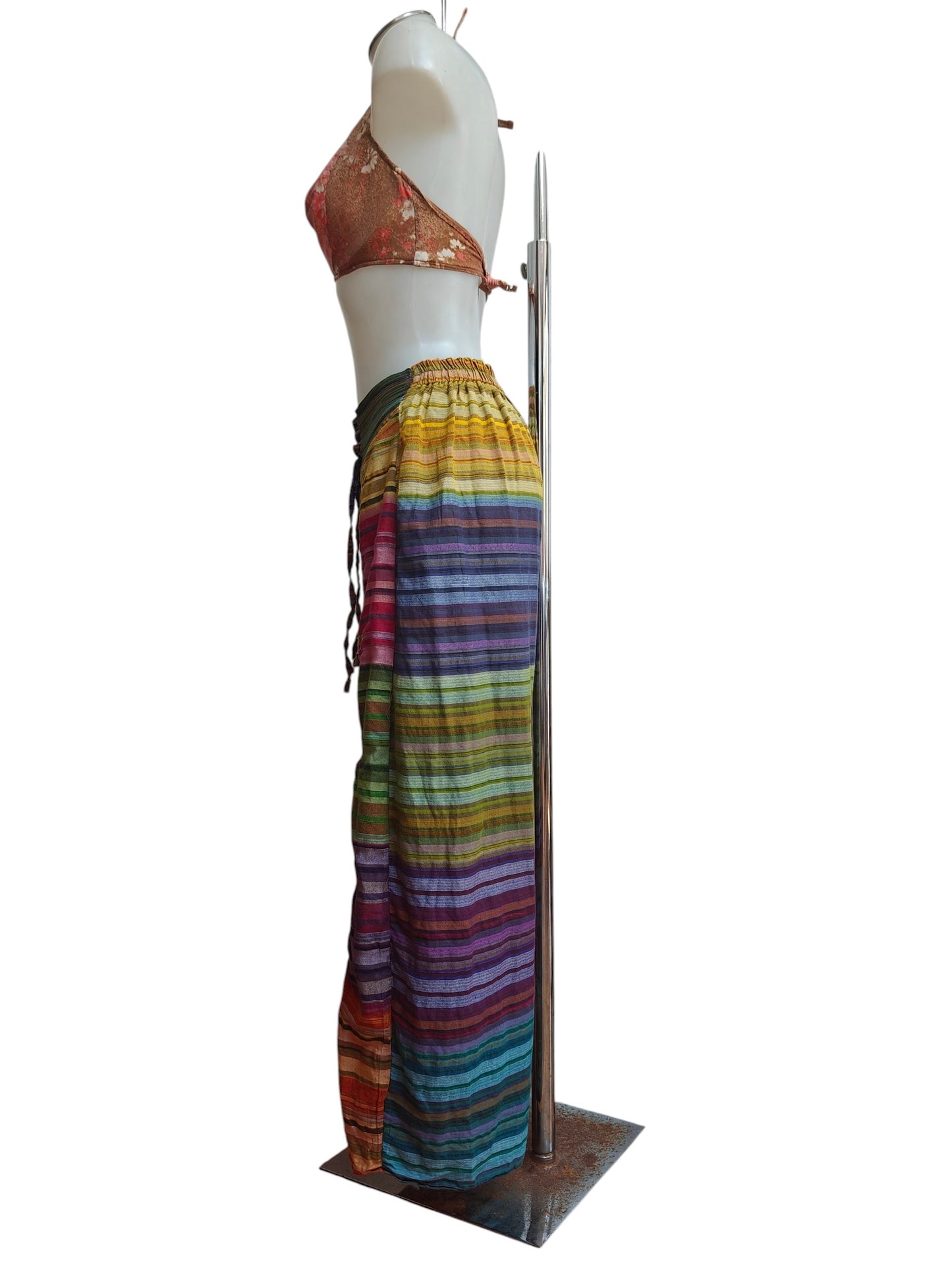 Mannequin wearing a colorful striped trousers on a white background