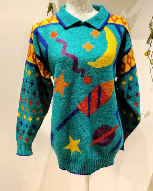 An incredible vintage jumper from the 80s. Very colourful and has a fab space theme. size 10-12.