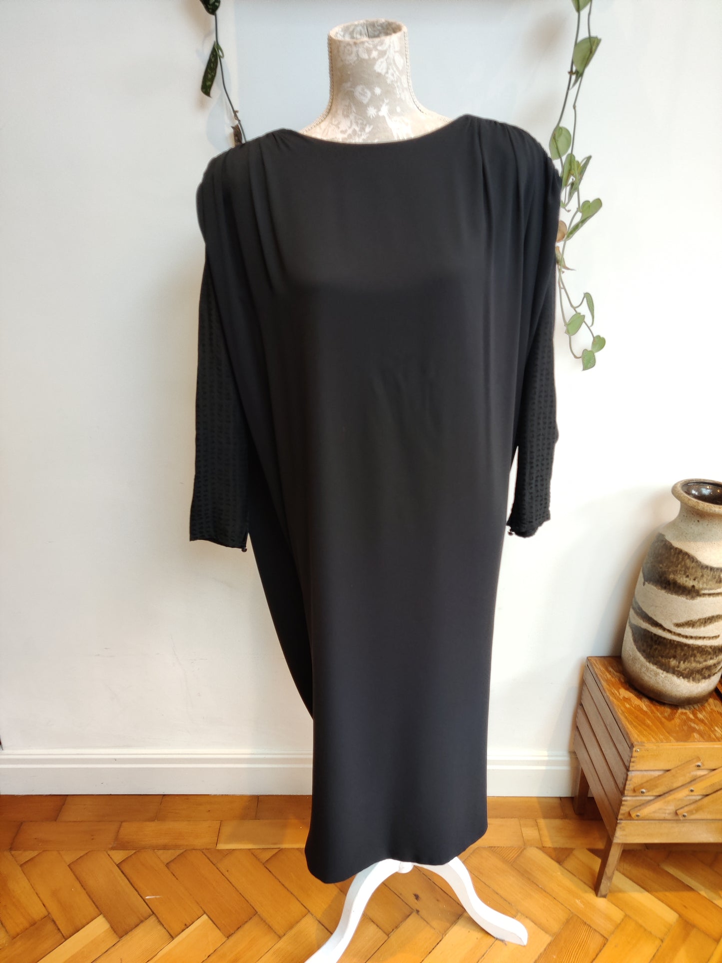Stunning vintage black dress with cape like drape back. Size 12-16.