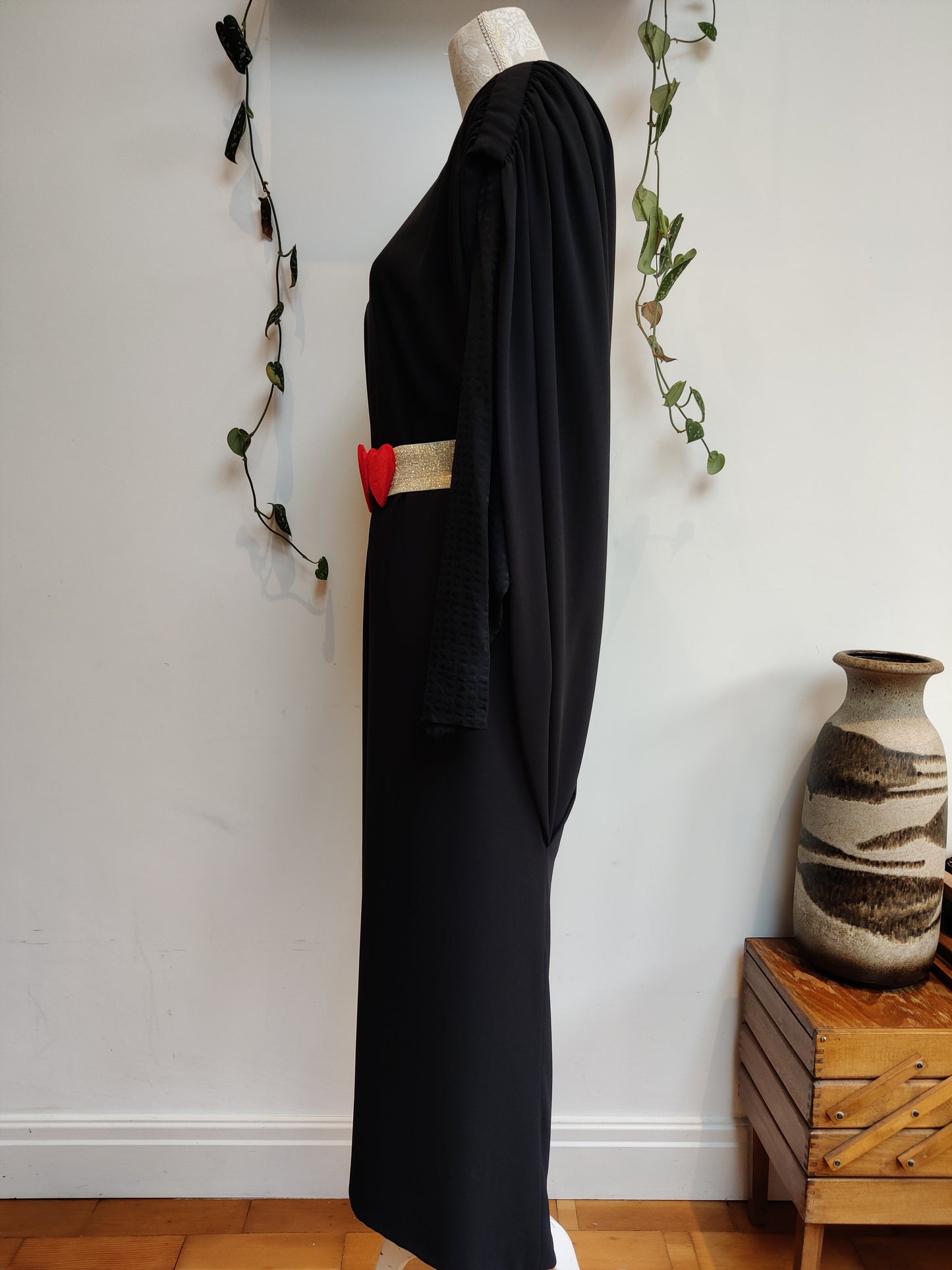 Stunning vintage black dress with cape like drape back. Size 12-16.